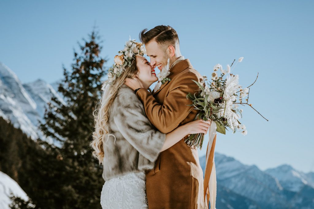 Paar küsst sich im Winter, Schweiz (Mountain Elopement)