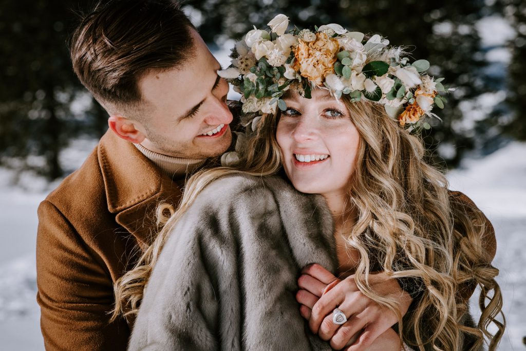 wedding couple laughs and hugs in swiss mountains